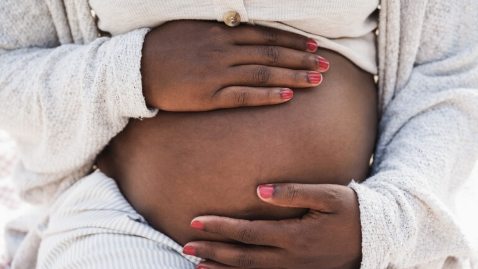 Close-up-of-african-pregnant-woman-holding-her-belly-Focus-on-hands-1340020013_2125x1417-768x512